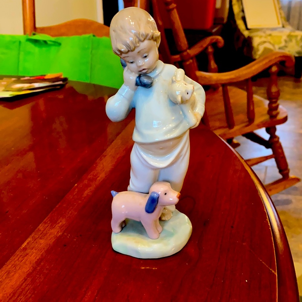 Little boy on phone with puppies, lladro figure